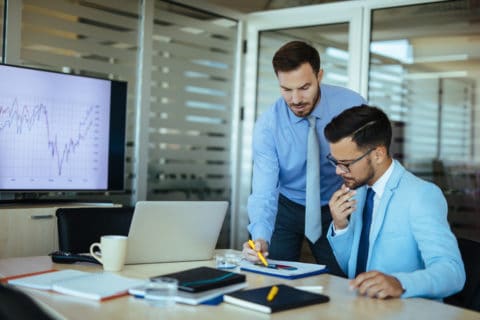 Two businessmen using Microsoft 365 for accounting firm for analytics.